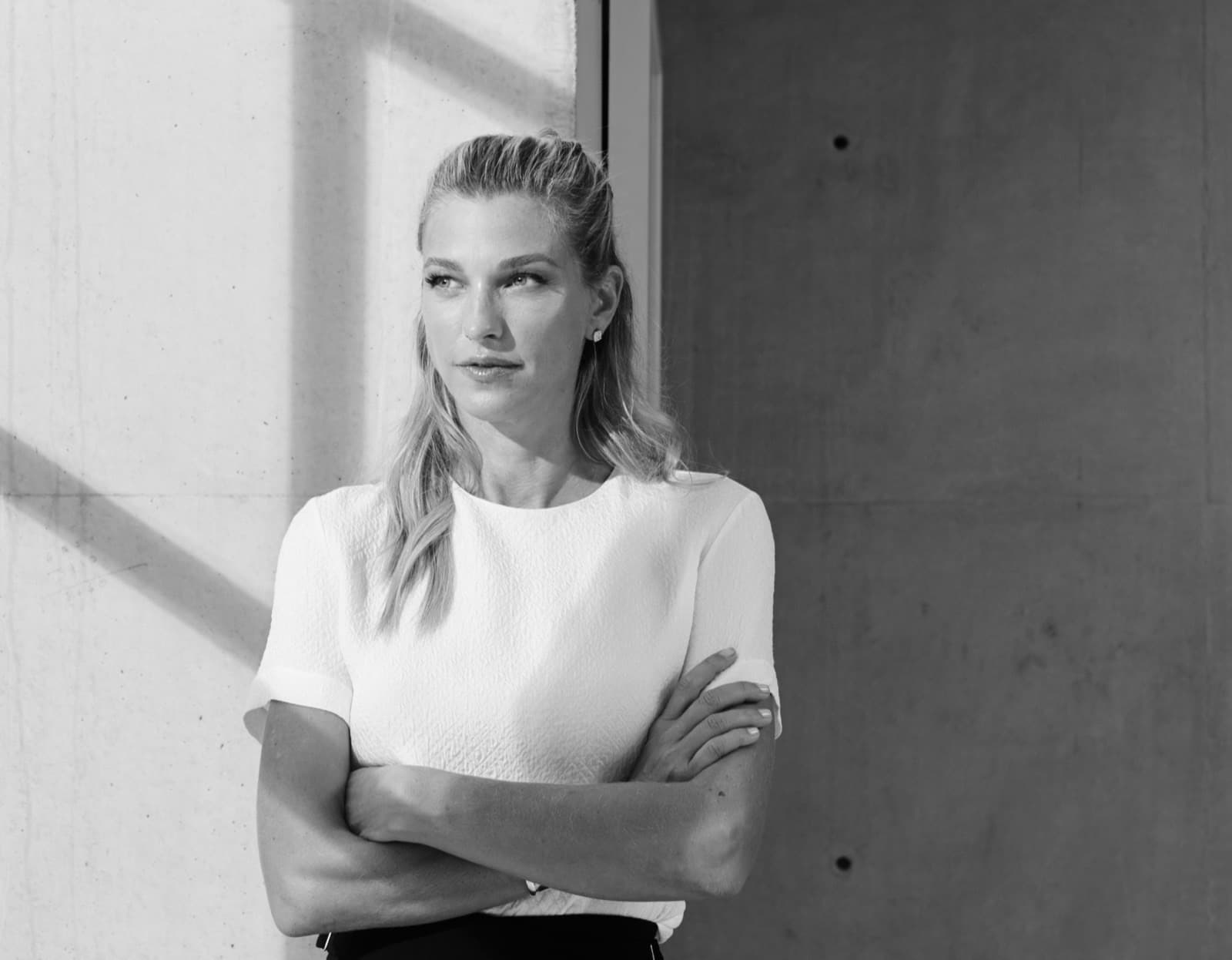 Nicole Junkermann in an ivory blazer with arms crossed, an editorial portrait of the investor and entrepreneur